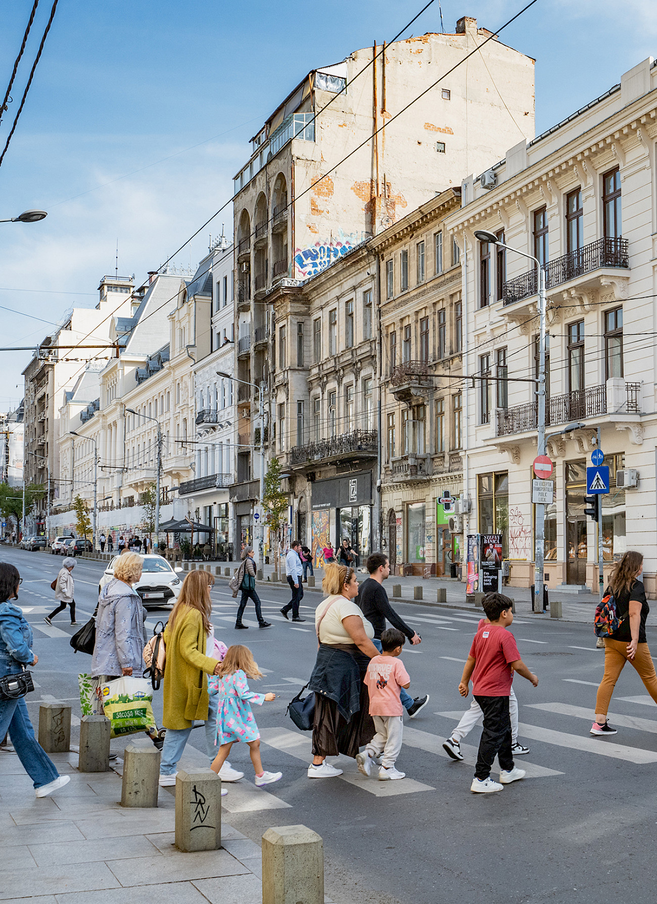 A busy street in Bucharest: pedestrians cross the street.