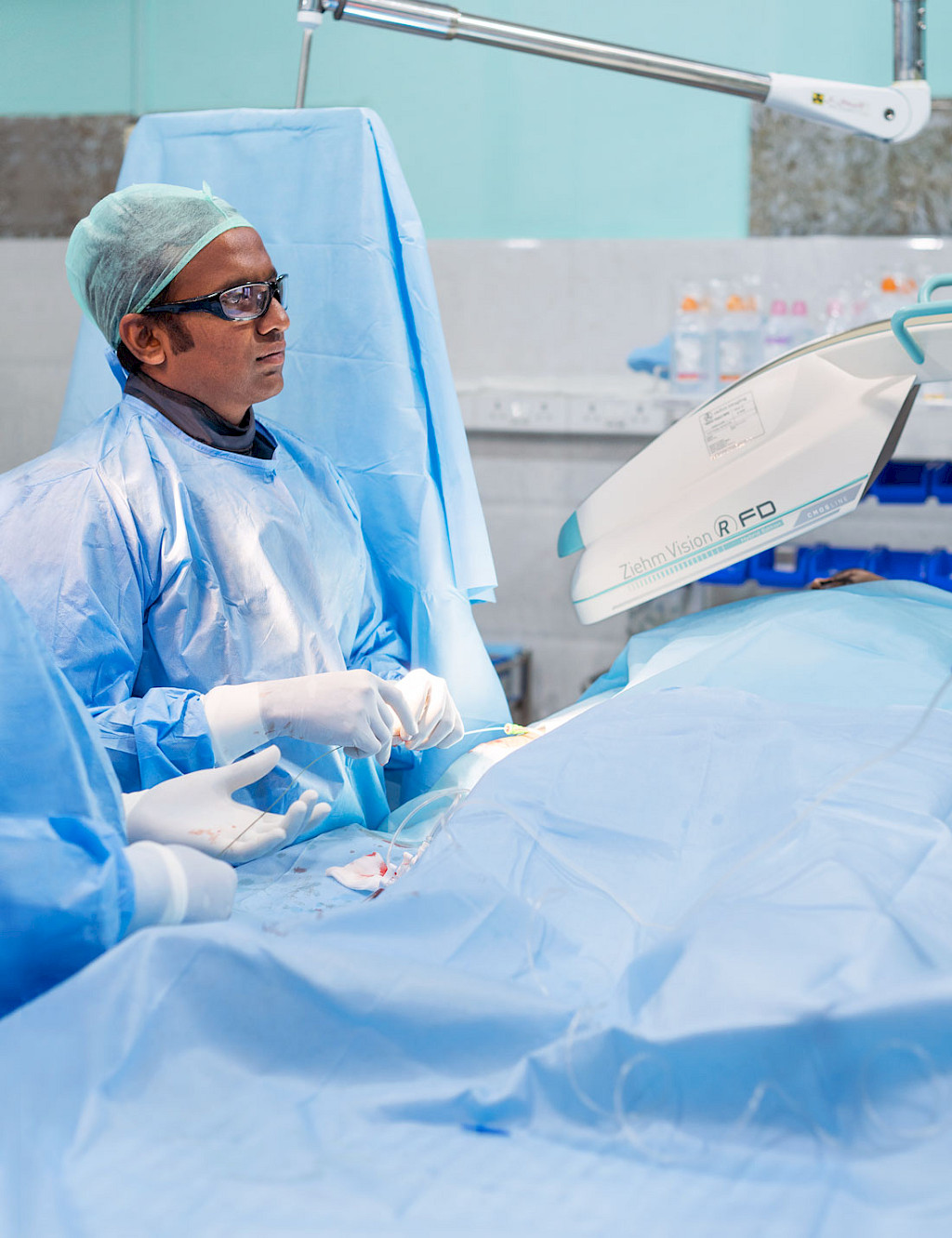 Rajarm Prasad in the mobile cath lab during the intervention. He guides the catheter wire.