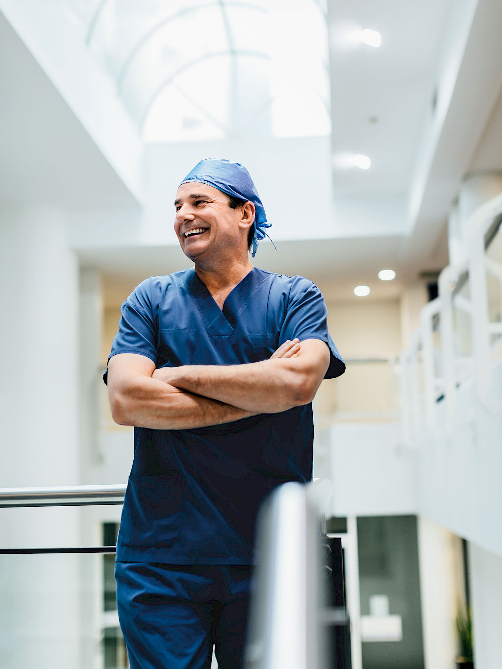 Portrait of Timothy Steel in surgical attire, taken in a hospital corridor.