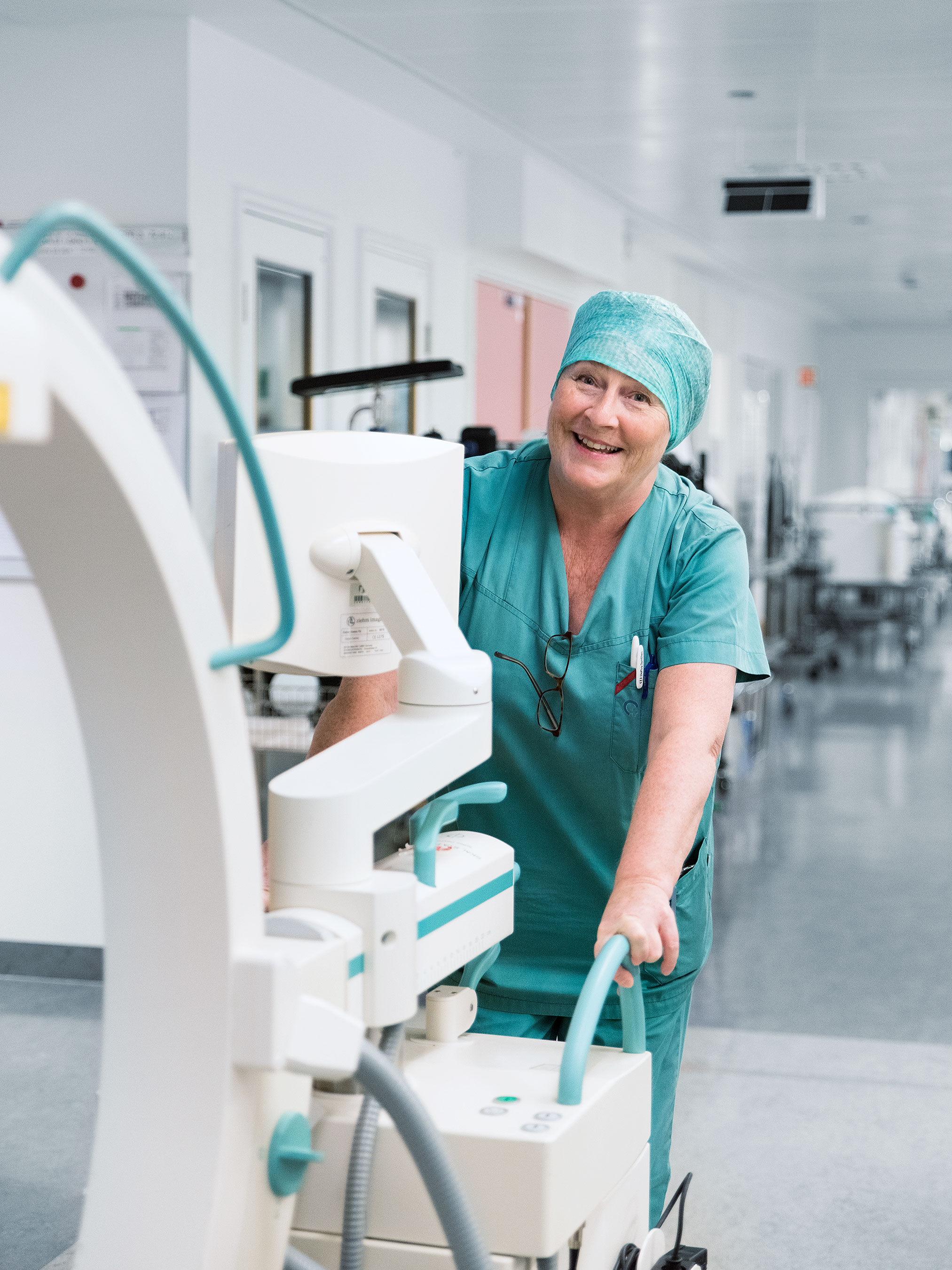 Trude Rosvold, the head surgical nurse, pushes a Ziehm Vision FD C-arm down a corridor.
